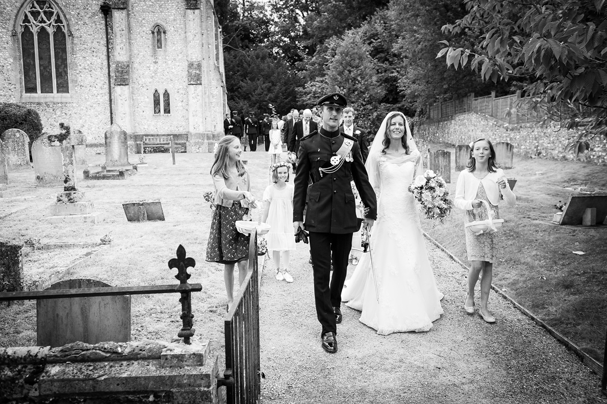  bride & groom leave church black & white wedding photography Ovington Hampshire