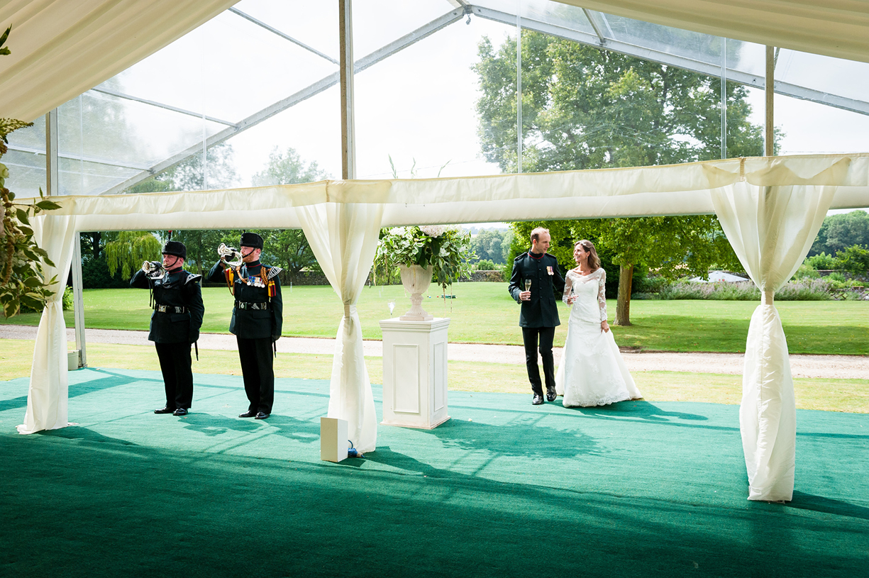 bride & groom enter marquee for wedding breakfast announced by Green Jackets buglers summer Ovington Hampshire